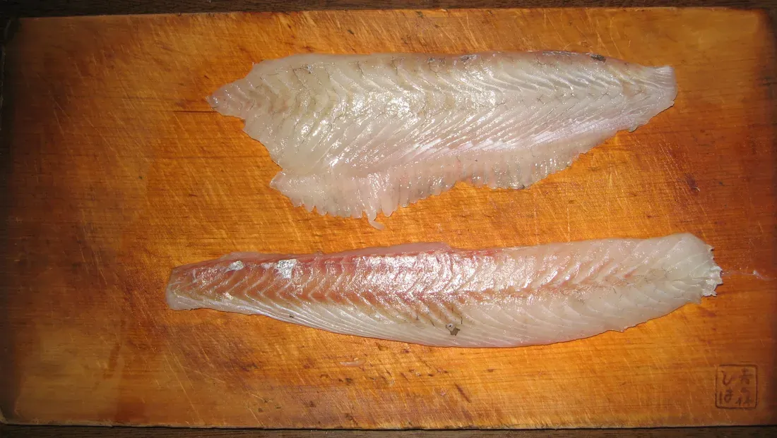 White flatfish fillets on a board